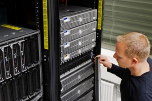 iStock_000019239419XSmall man looking at tower of servers