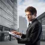 man in suit holding a tablet computer