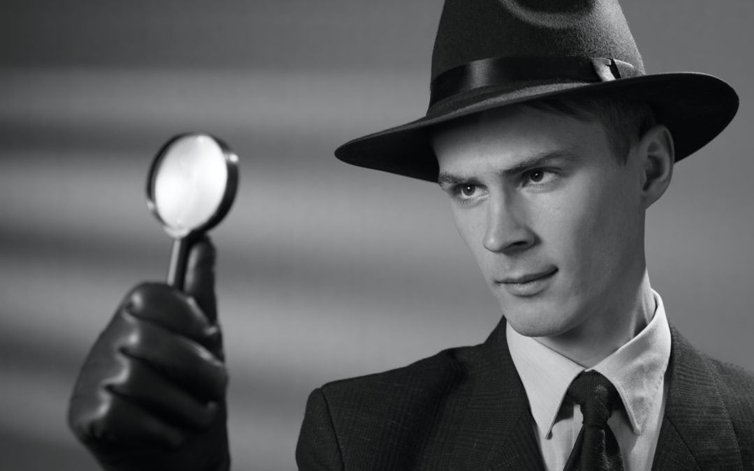 photo of detective with magnifying glass on a book scavenger hunt